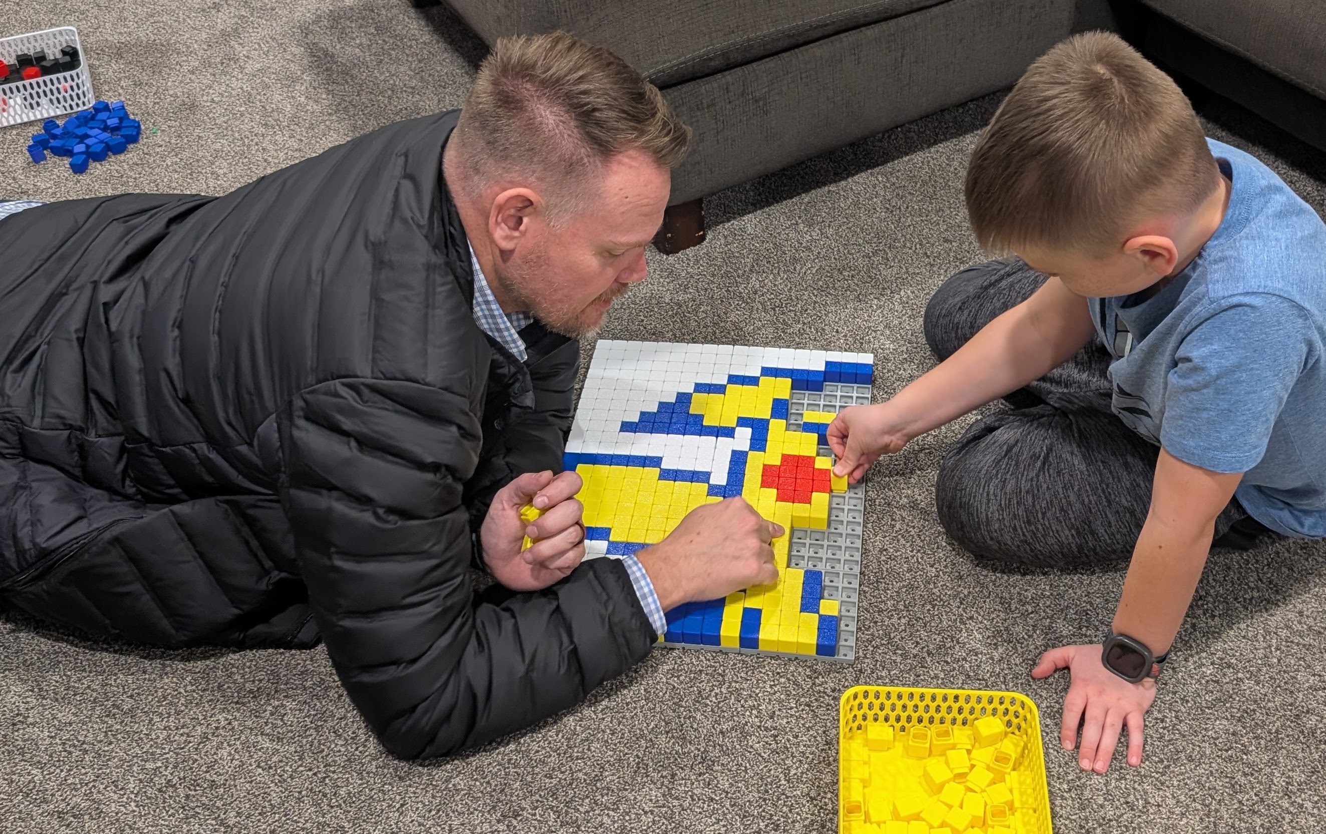 A father and son assembling Klixel wall art together