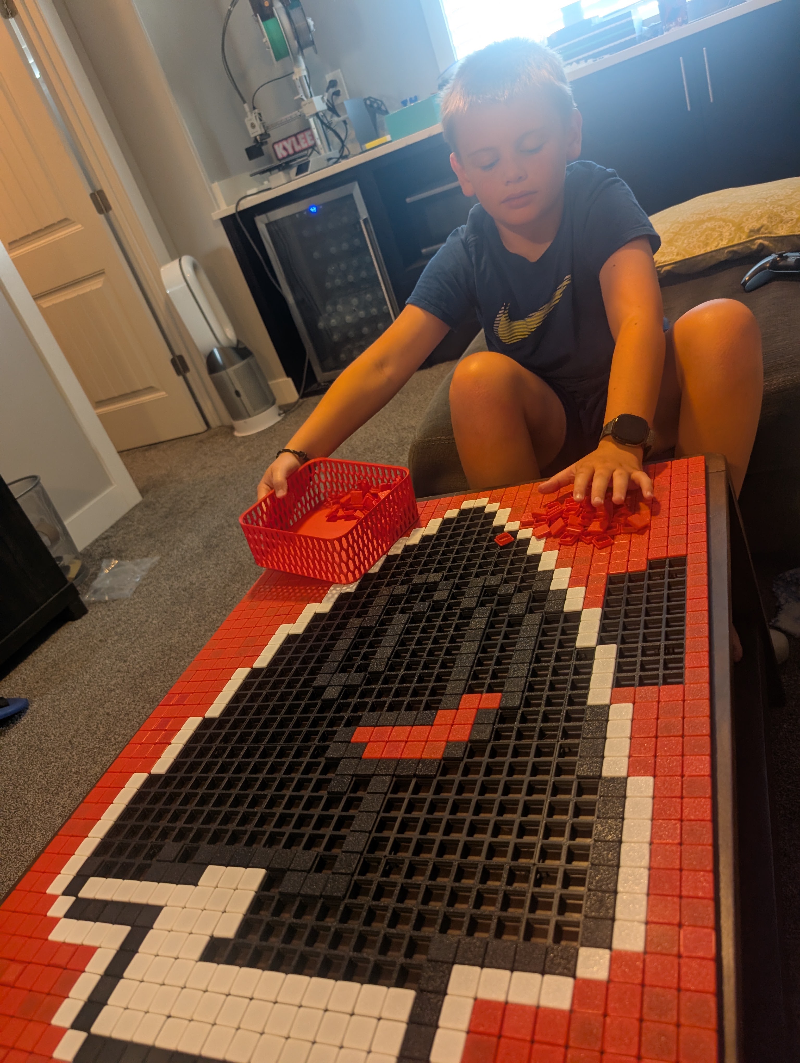 A child snapping red, black and white Klixels into modular grids
